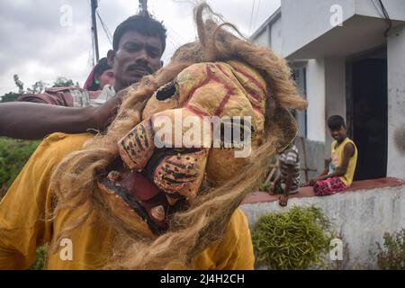 Hoogly, India. 12th Apr, 2022. A cosplayer being prepared for performance during the Gajan festival at Hooghly. Gajan is a Hindu festival celebrated mostly in West Bengal as well as southern part of Bangladesh during the end of the month of Ã¬ChaitraÃ® of the Bengali calendar followed by another festival named Ã¬CharakÃ®. This festival is mainly worshipping Hindu Lord Shiva and Parvati before the start of the harvesting season. Gajan is actually connected to the people who are related to the agricultural community, directly or indirectly. People celebrate by performing rituals such as face p Stock Photo