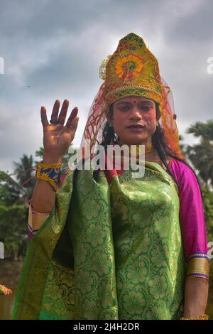 Hoogly, India. 12th Apr, 2022. A cosplayer poses for photos during the Gajan festival at Hooghly. Gajan is a Hindu festival celebrated mostly in West Bengal as well as southern part of Bangladesh during the end of the month of Ã¬ChaitraÃ® of the Bengali calendar followed by another festival named Ã¬CharakÃ®. This festival is mainly worshipping Hindu Lord Shiva and Parvati before the start of the harvesting season. Gajan is actually connected to the people who are related to the agricultural community, directly or indirectly. People celebrate by performing rituals such as face painting and co Stock Photo