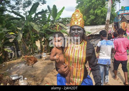 Hoogly, India. 12th Apr, 2022. A cosplayers poses with his son during the Gajan festival. Gajan is a Hindu festival celebrated mostly in West Bengal as well as southern part of Bangladesh during the end of the month of Ã¬ChaitraÃ® of the Bengali calendar followed by another festival named Ã¬CharakÃ®. This festival is mainly worshipping Hindu Lord Shiva and Parvati before the start of the harvesting season. Gajan is actually connected to the people who are related to the agricultural community, directly or indirectly. People celebrate by performing rituals such as face painting and cosplaying Stock Photo