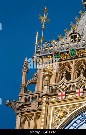 Upper detail of recently uncovered restored Elizabeth Tower, Big Ben, of the Palace of Westminster, London. Bright colours. Ornate features of spire Stock Photo