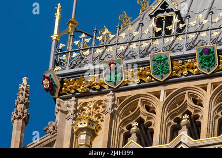 Upper detail of recently uncovered restored Elizabeth Tower, Big Ben, of the Palace of Westminster, London. Bright colours. Plant badges, shields Stock Photo