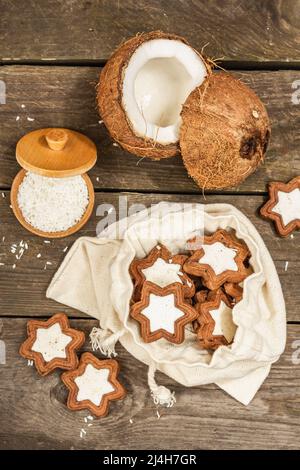 Gluten-free and lactose-free coconut cookies. Homemade healthy pastries, vegan lifestyle. Rustic style, wooden background, top view Stock Photo