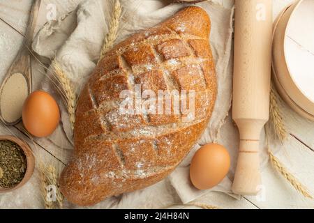 Different sorts of bread with wheat and eggs, top view. The concept of a bakery and food store. Stock Photo