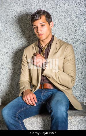 Man Waiting for You. Wearing a blue blazer, black pants,, short haircut, a  young black guy is standing against metal fences by a tennis court, staring  Stock Photo - Alamy