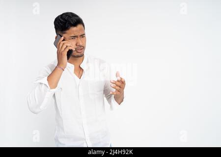 man shocked and angry while talking on his smartphone Stock Photo