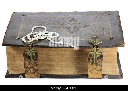 rosary on vintage bible isolated on white background Stock Photo