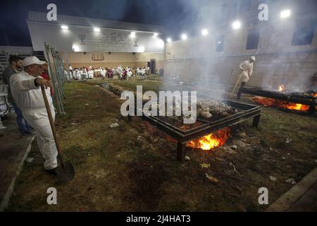 Nablus, Palestine. 14th Apr, 2022. Members of the ancient Samaritan community burn the remains of sacrifices during their participation in the Passover rituals on Mount Gerizim, overlooking the West Bank city of Nablus. The Samaritans are descended from the ancient Israelite tribes of the Menashe and Ephraim but separated from mainstream Judaism 2,800 years ago. Today, the remaining 700 Samaritans live in the West Bank Palestinian city of Nablus and the Israeli port city of Holon south of Tel Aviv. Credit: SOPA Images Limited/Alamy Live News Stock Photo