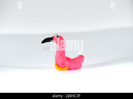 Plasticine flamingos. Toys made of plasticine on a white background. Stock Photo