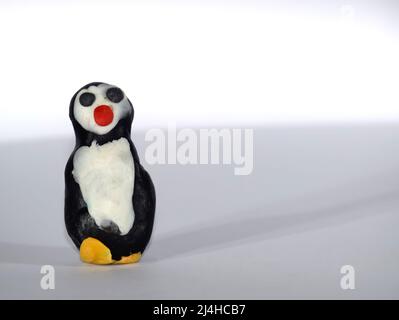 Plasticine penguin. Toys made of plasticine on a white background. Stock Photo