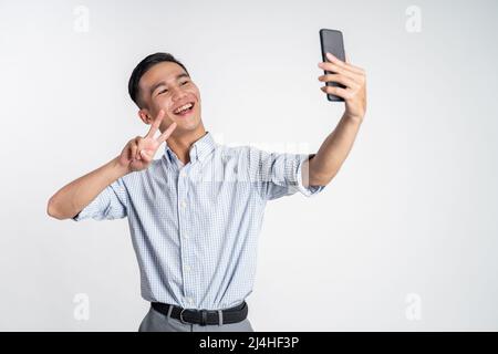 happy asian man taking selfie with phone camera Stock Photo