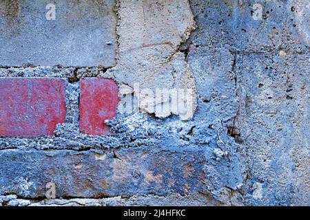 Grunge background with wall with different brick stones and cement Stock Photo