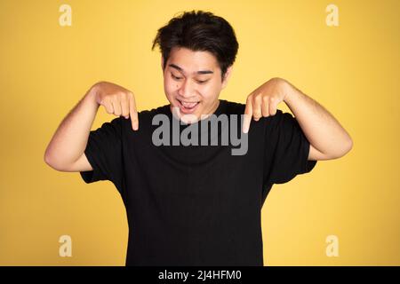 excited young man with two fingers pointing down Stock Photo