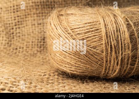 Linen rope roll and natural linen fabric texture.  Soflt light and isolated view. Stock Photo