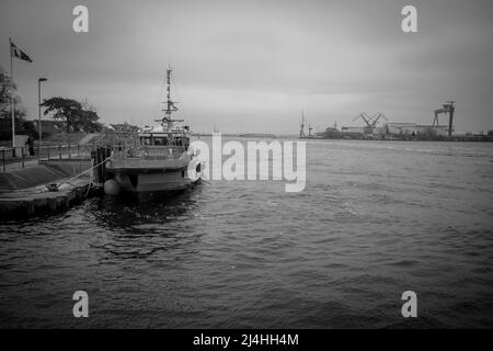 in the port of Rostock lies a orange distress rescue ship Stock Photo