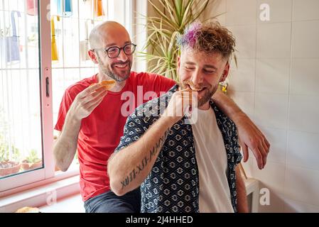 Two gay men in the kitchen having breakfast Stock Photo
