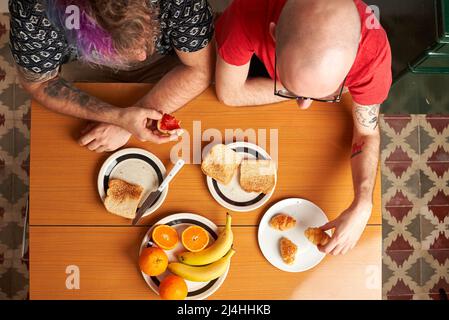 Top view of a table in the kitchen with two gay men having breakfast Stock Photo