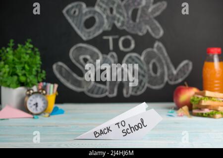 Inscription back to school on airplanes from paper in the background school board Stock Photo