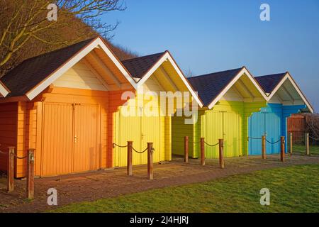 UK, North Yorkshire, Scarborough, Colourful Beach Chalets above North Bay Promenade Stock Photo