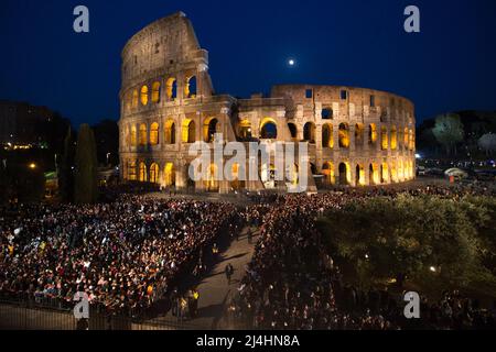 Rome, Italy. 15th Apr, 2022. People attending outside the Colosseum on the evening of the Good Friday, where Pope Francis, Jorge Mario Bergoglio, celebrated the Via Crucis / Way to the Cross. Credit: LSF Photo/Alamy Live News Stock Photo