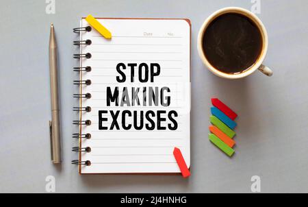 stickers and notepad on a gray background. text on notebook. STOP MAKING EXCUSES. Stock Photo