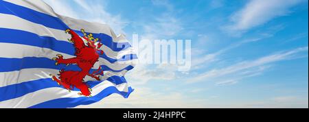 official flag of Official Province of Luxembourg, Belgium at cloudy sky background on sunset, panoramic view. Belgian travel and patriot concept. copy Stock Photo