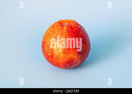 blood red orange citrus fruit on blue background. red orange Stock Photo