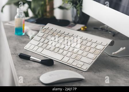 The man cleaning his computer keyboard. Grimy, more bacteria on keyboard. Stock Photo