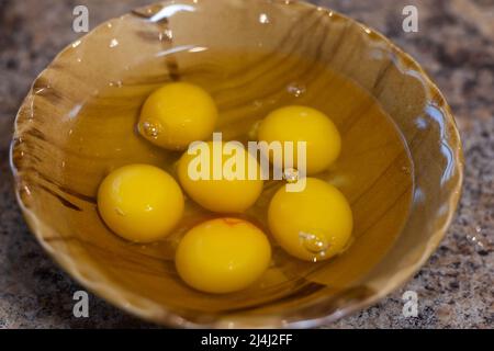 closeup of a bowl with cracked chicken eggs in a kitchen worktop Stock Photo