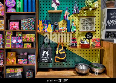 Gifts wrapped on shelf display unit providing a colourful assortment of wrapped gifts Stock Photo