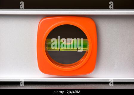 Fragment of the bubble level with the indicator flask in the center of the construction spirit level tool Stock Photo