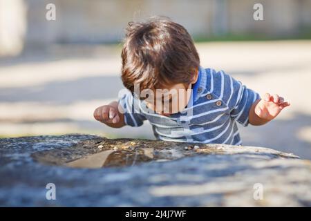 Portrait of a little eastern handsome baby boy playing outdoor in the park Stock Photo