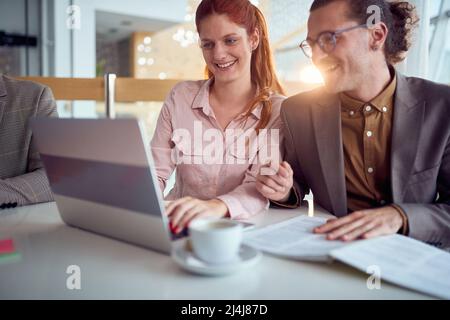 Two young work colleagues having a break in the office Stock Photo