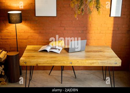 Stylish and cozy workplace with a wooden table at home Stock Photo
