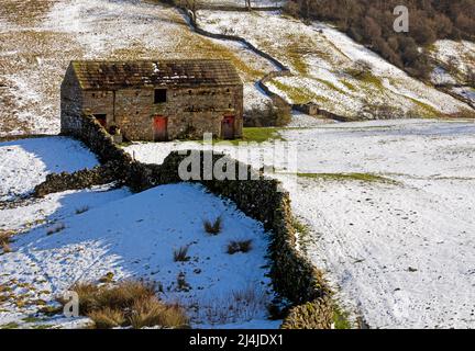 Stone barn near Angram in Swaledale, Yorkshire Dales National Park. Snow covered fields in late February.