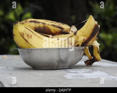 An isolated close-up shot of banana peel on a steel bowl with defocused background. Stock Photo