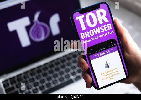 SPB, Russia - April 15, 2022: Person uses Tor Browser with VPN app. Icon close-up. Smartphone with private and safe browser, VPN application photo Stock Photo