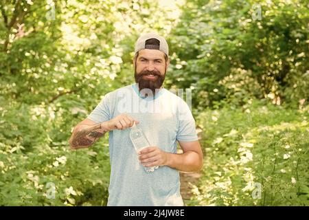 guy maintains body water balance. hydration. daily water. brutal bearded man drink bottle. Stock Photo