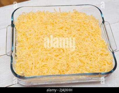 Top view of uncooked lasagna in transparent tray on a wooden background Stock Photo