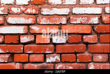 Old red brick wall with weathered white paint, high detailed texture background Stock Photo