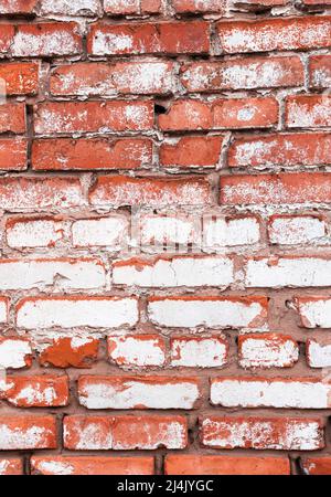 Old red brick wall with weathered white paint, high detailed texture background Stock Photo