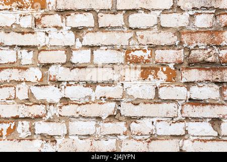 Old brick wall with weathered white paint, high detailed texture background Stock Photo