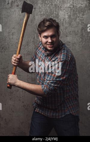 Portrait of bearded man with axe posing in studio Stock Photo