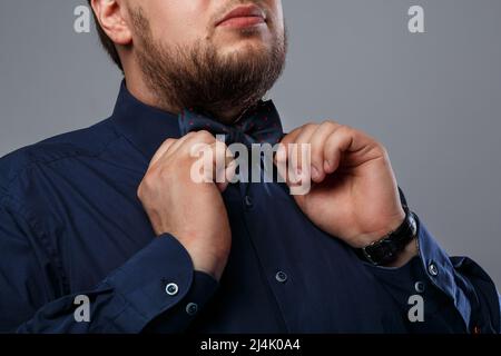Close up shot of Bearded man wearing bow tie Stock Photo