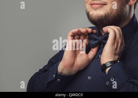 Close up shot of Bearded man wearing bow tie Stock Photo