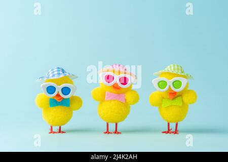 Different cute chickens on blue background. Spring Easter minimal concept. Stock Photo