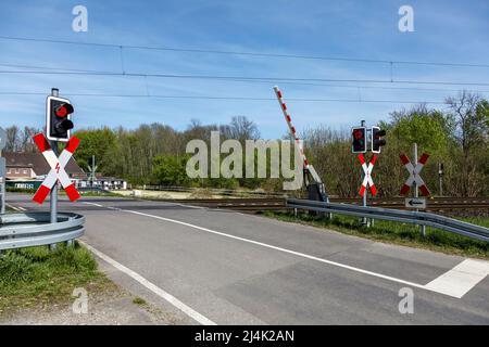 Closing barriers at the level crossing Stock Photo
