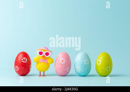 Holiday layout with chicken and colorful Easter eggs. Creative Easter minimal concept. Stock Photo