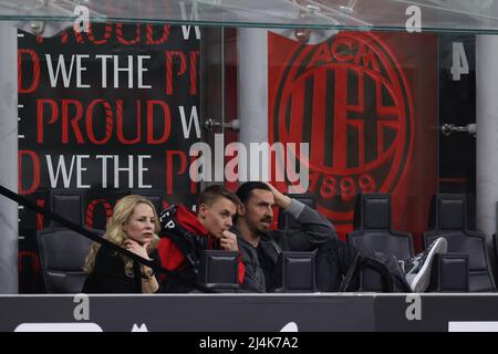 Milan, Italy, 15th April 2022. Zlatan Ibrahimovic of AC Milan reacts as he looks on from the stands with his wife Helen Seger and son Maximilian during the Serie A match at Giuseppe Meazza, Milan. Picture credit should read: Jonathan Moscrop / Sportimage Stock Photo