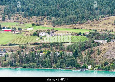 Waterfront land terrace with farm fields and residential houses built on it Stock Photo