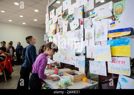 Dnipro, Ukraine - April 04, 2022: Children draw pictures a in a Refugee Relief Center in Dnipro. Wall with children's drawings against the war in Ukra Stock Photo